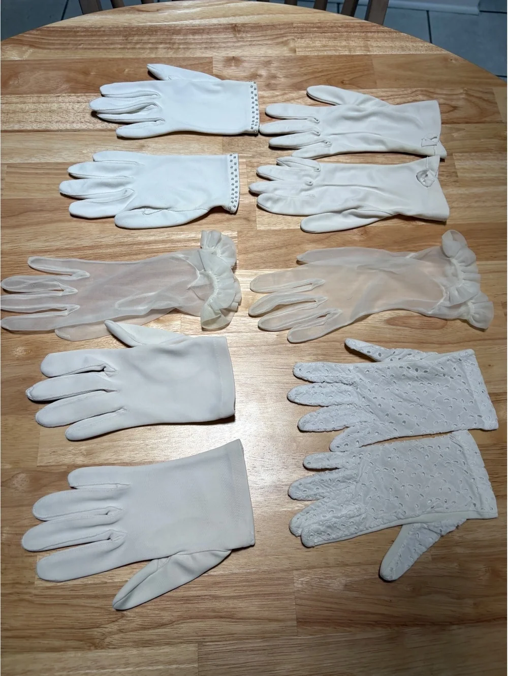 Five pairs of dress gloves. One pair of opera length gloves. Small size.